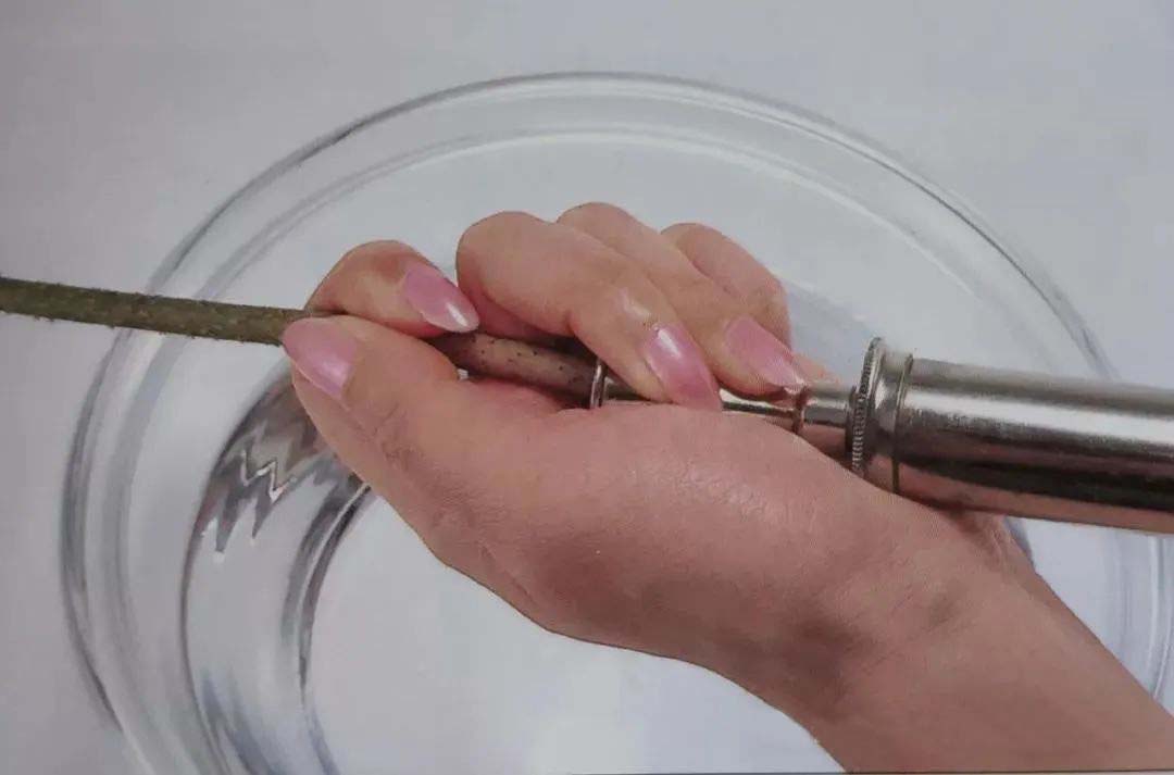 The incision is cut flat and the syringe is pushed gently with one hand holding down the incision.